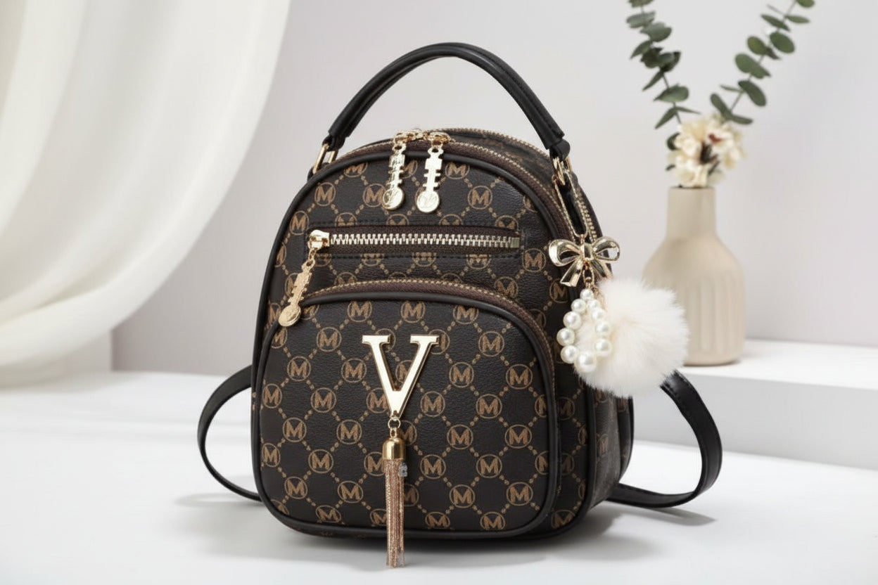 Designer handbag with monogram pattern on a white surface