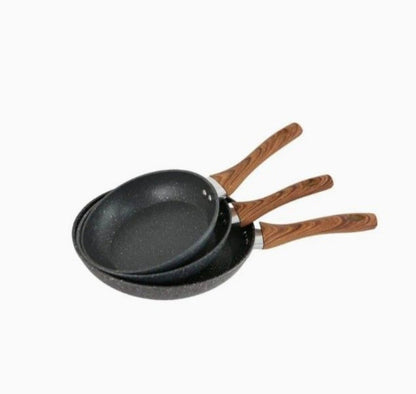 Three black frying pans with wooden handles on a white background
