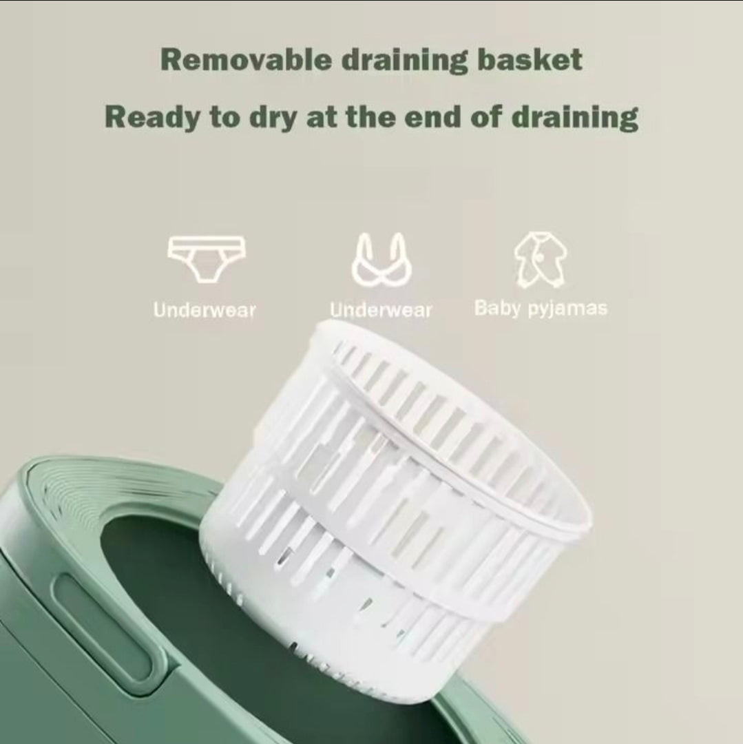 White removable draining basket shown partially inserted into a green appliance, with text reading 'Removable draining basket Ready to dry at the end of draining' and icons for underwear and baby pyjamas.