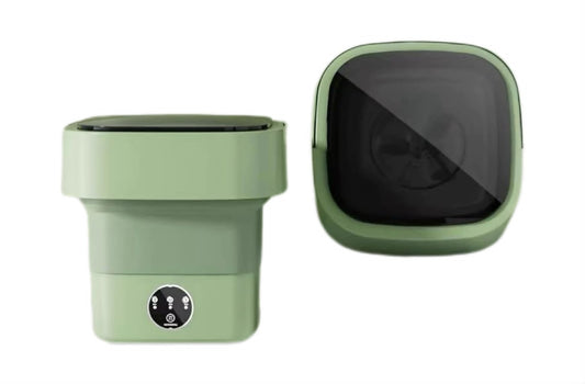 A compact, foldable green washing machine shown from two angles on a plain white background: one showing the front with a small circular control panel, and the other showing the back with a large dark reflective panel.