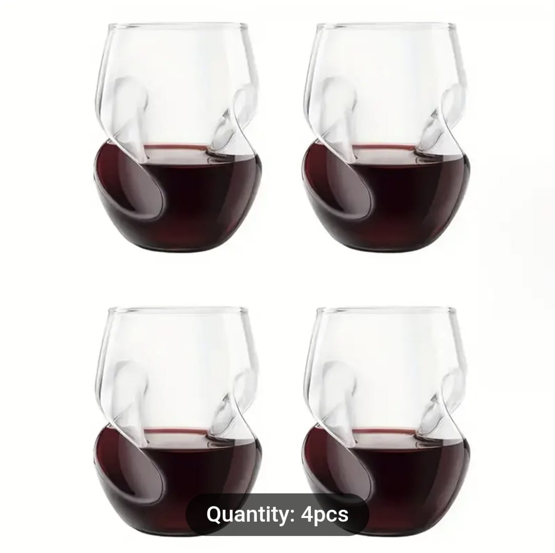 Four stemless wine glasses filled with red wine on a white background