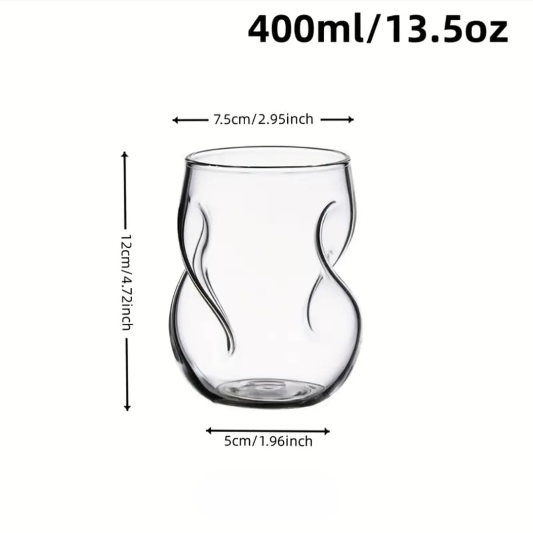 Clear glass tumbler with measurements on a white background