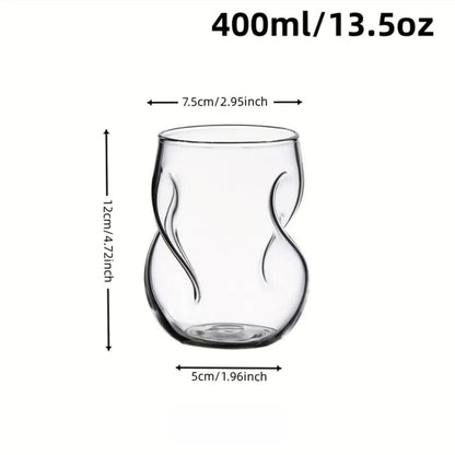 Clear glass tumbler with measurements on a white background