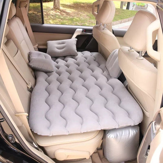 Inflatable car mattress installed in a vehicle with air pump visible