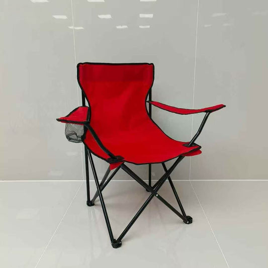 Red folding chair with black frame on a white tiled floor