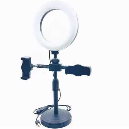 Ring light with stand and phone holder on a white background