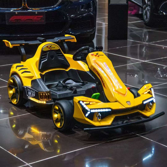 Yellow toy go-kart on a reflective floor with a car in the background