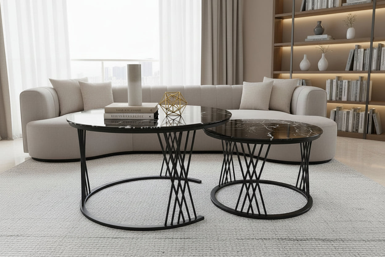 Two black marble side tables with decorative items on a tiled floor.