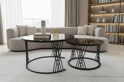 Two black marble side tables with decorative items on a tiled floor.