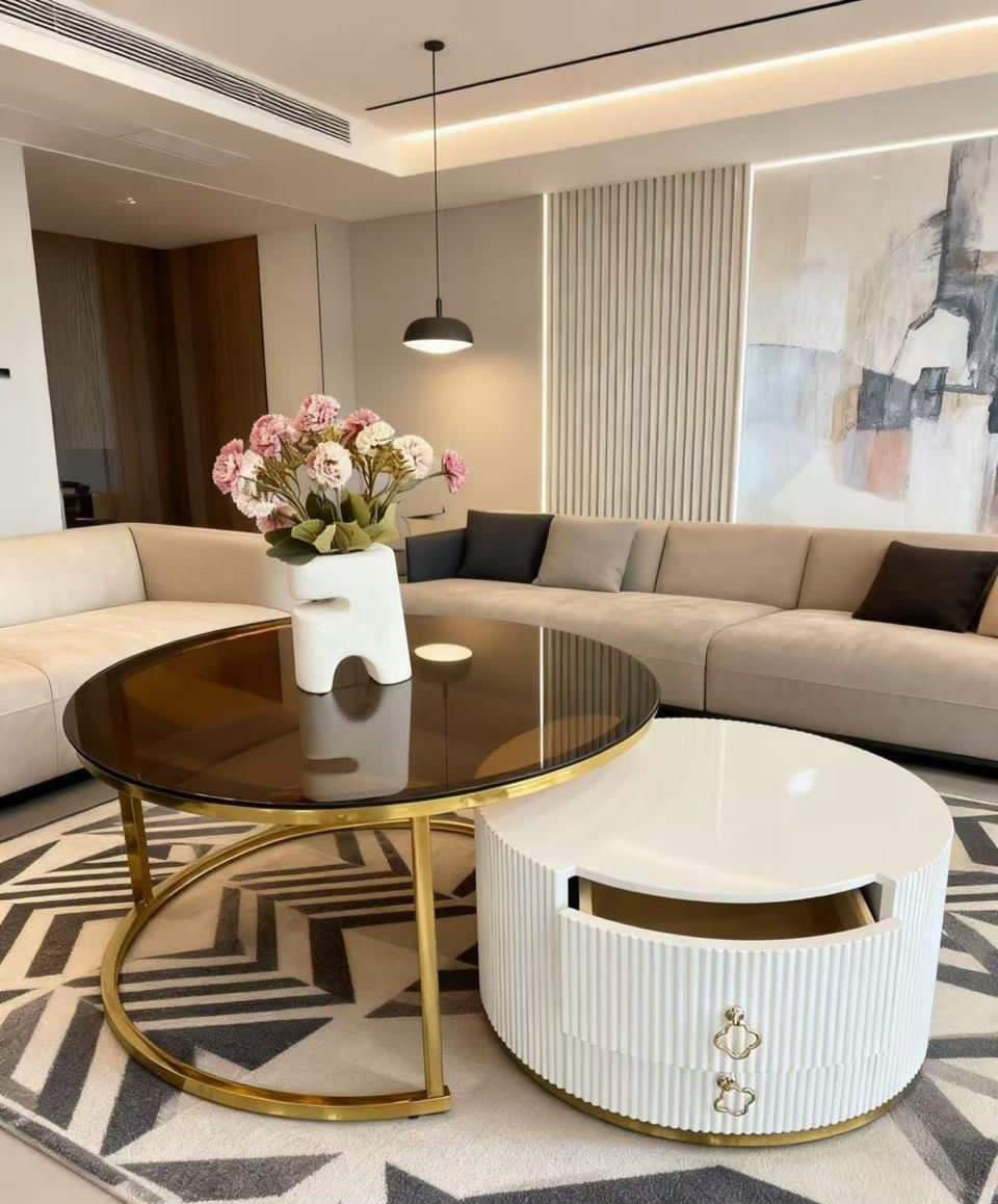Modern living room with a sectional sofa, coffee table, and decorative elements.