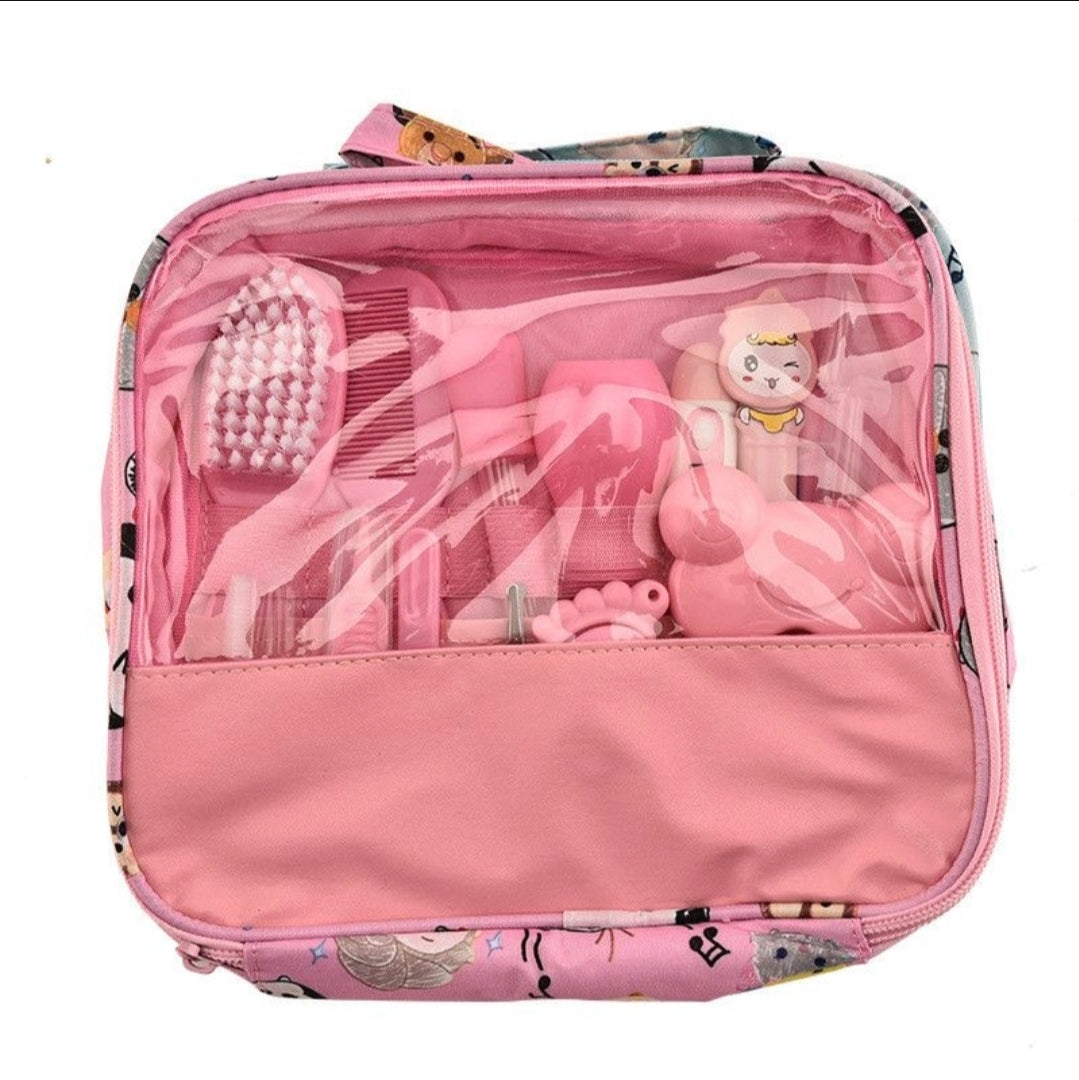 Pink travel case with hairbrush, hair accessories, and a toy inside on a white background