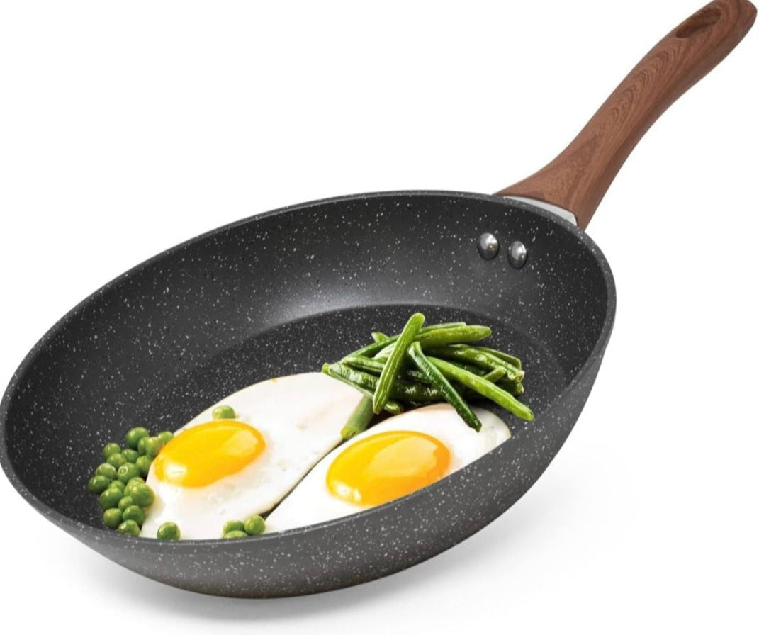Frying pan with eggs and green beans on a white background